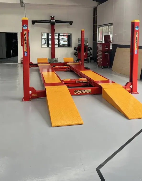A car on Tyre Lab's four-wheel alignment lift