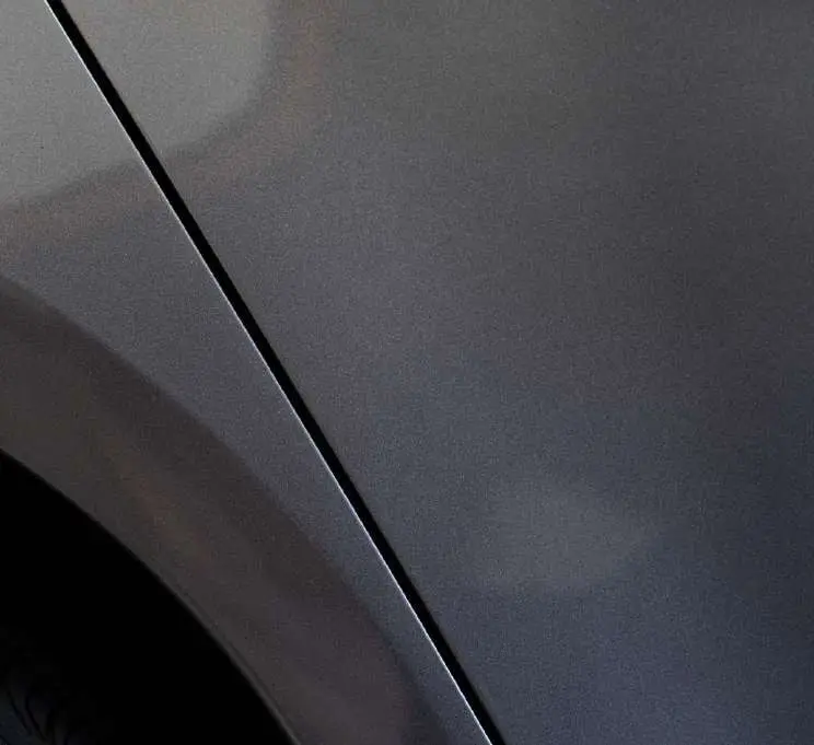 A deep scratch on a grey side panel, after the repair